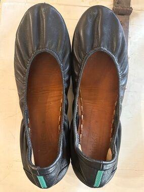 Tieks Black Leather Slip-Ons with Teal Heel Tab Accent